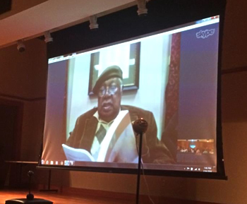 Large screen shows author Ernest Gaines skyping in for the audience.