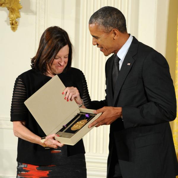 Karen Hopkins receiving an award from Barack Obama