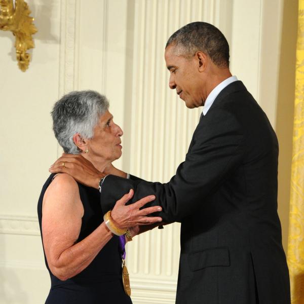 Joan Harris receiving an award from Barack Obama