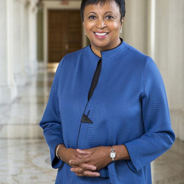 Portrait of Carla Hayden in a hall in the Library of Congress. 