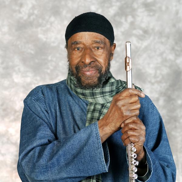 Portrait of man holding flute. 