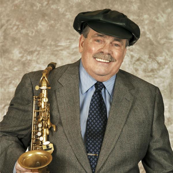 Portrait of Phil Woods holding saxophone