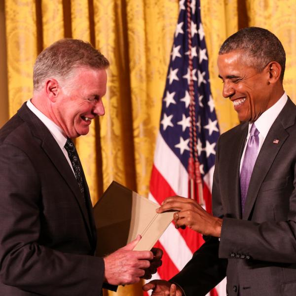Edward P. Henry receives a medal from President Obama.
