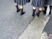 Legs and skirts of uniformed school girls