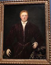 oil painting by Tintoretto of a woman wearing rich looking dark red garments