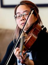 A woman plays a viola