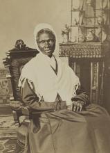 Sojourner Truth sitting in a chair with a shawl over her shoulders