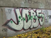 graffiti on a wall that says jobs