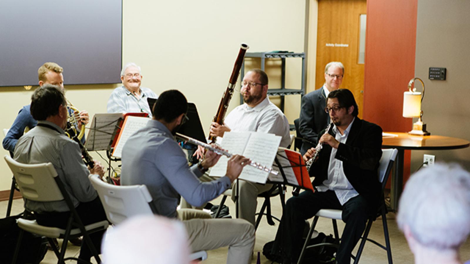 Musicians playing for an elderly audience